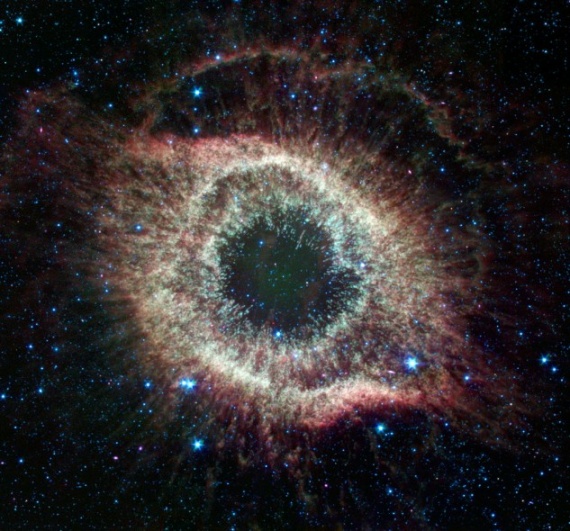 A newly expanded image of the Helix nebula lends a festive touch to the fourth anniversary of the launch of NASA's Spitzer Space Telescope.